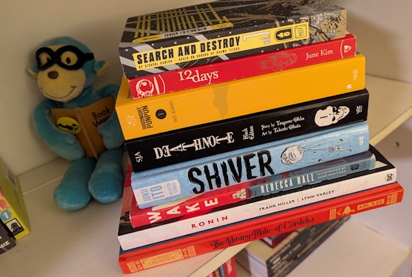 A stack of eight comics and manga I'm planning to read in 2025.