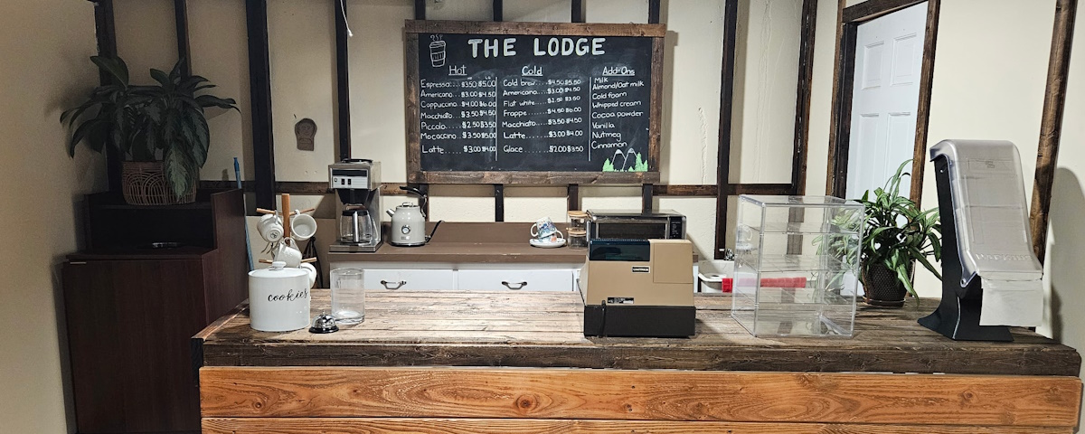 A cafe sign in the background (The Lodge), with the counter in the foreground.